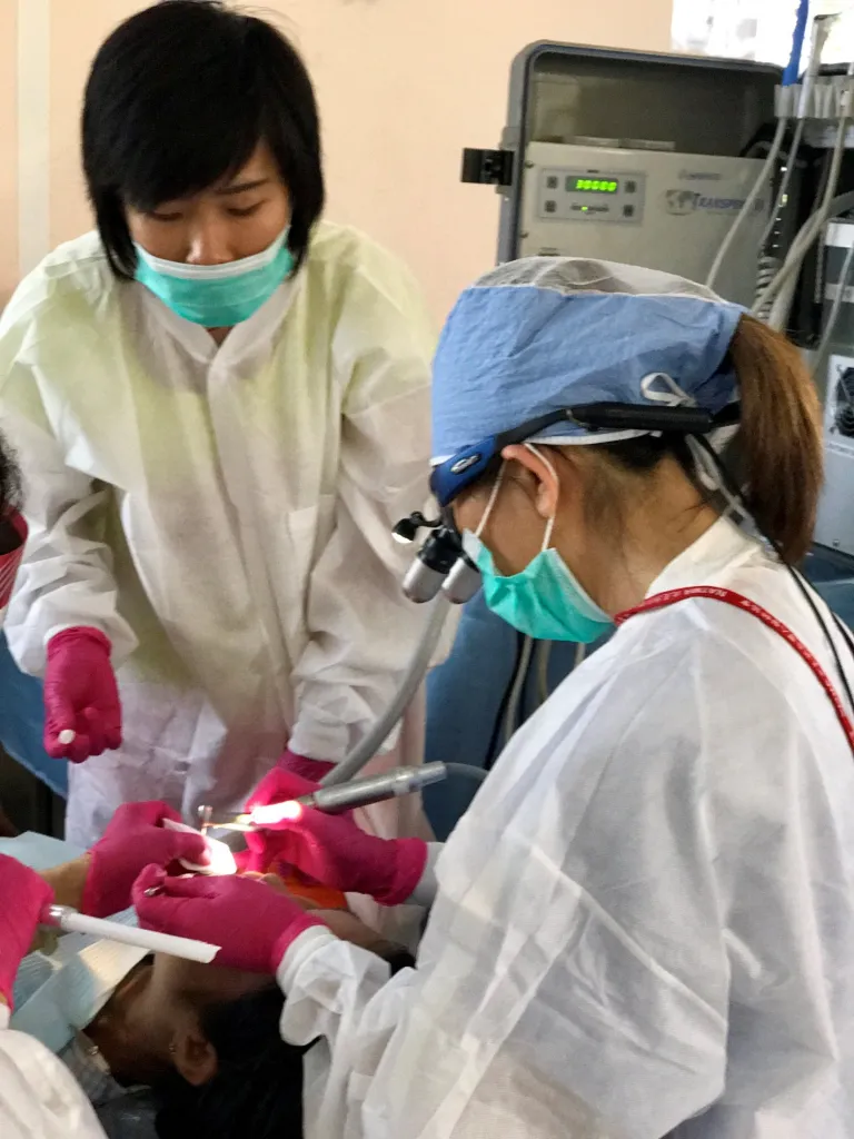 Dr. Yeh performing a dental procedure on a patient