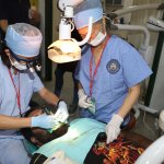 Dr. Yeh and a staff member doing charity work on a patient