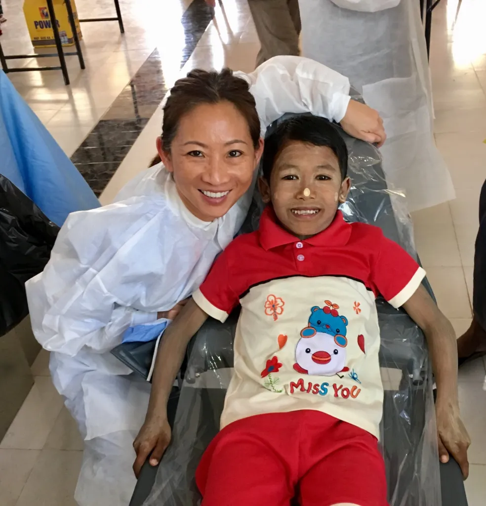 Dr. Yeh with a child patient on her mission trip